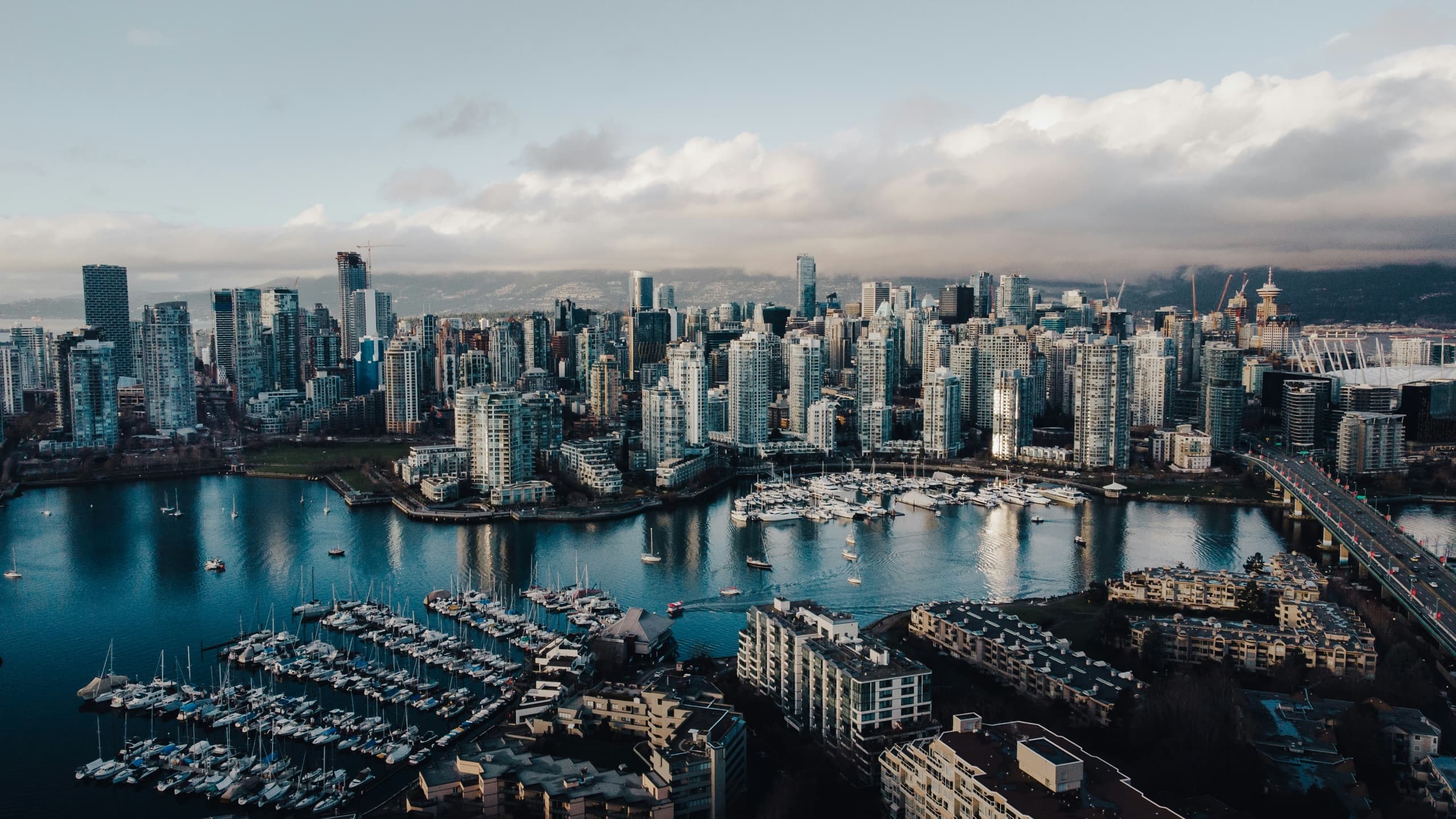 Aerial view of downtown Vancouver and False Creek under a cloudy sky